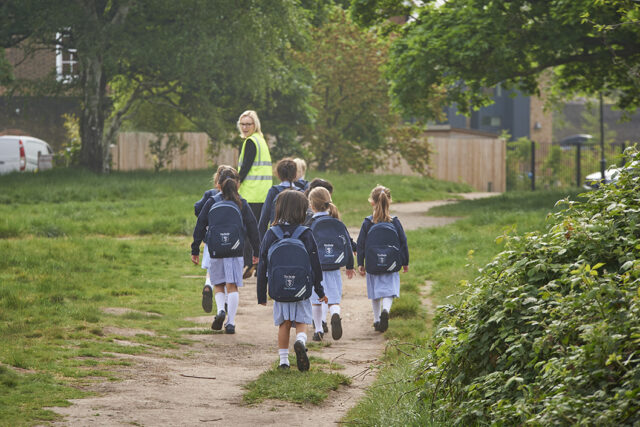 Study pupils walking with a teacher on Wimbledon Common