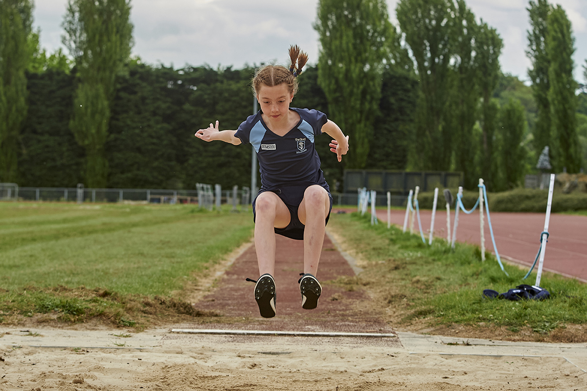 Study girl taking part in high jump at Wibledon Park Athletics Track