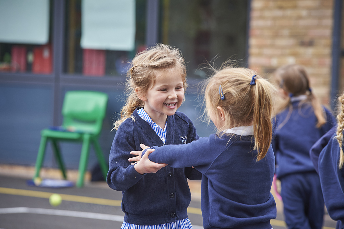 Study girls hugging in Wilberforce House playground