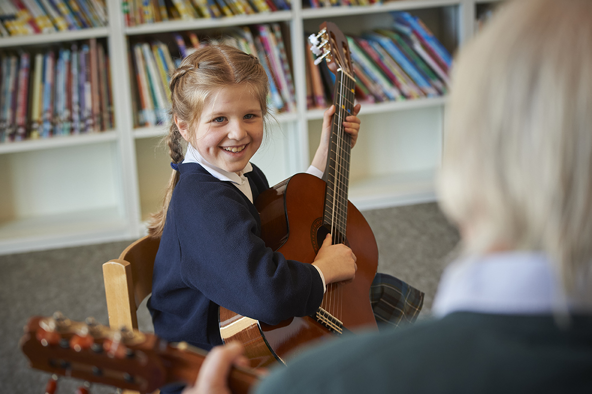 Study girl in guitar lesson