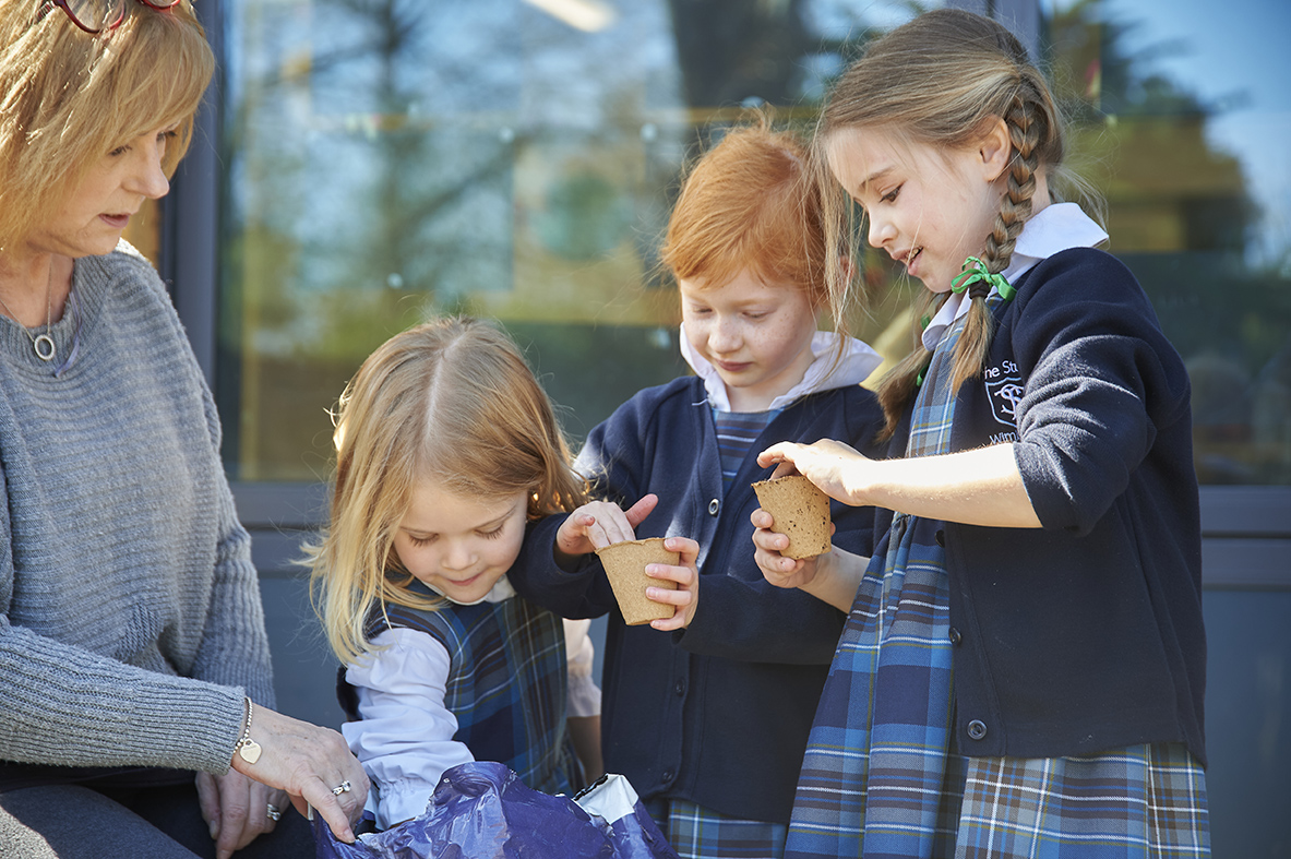 Study girls potting seeds